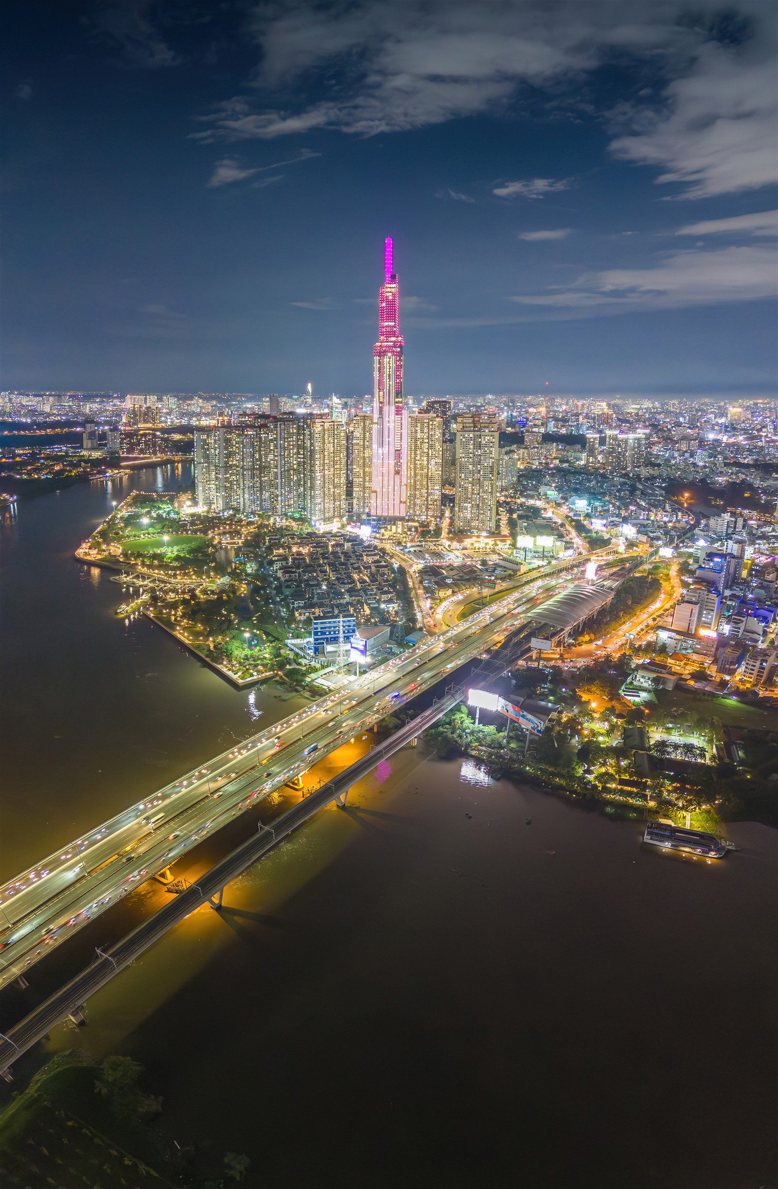 Landmark 81 and apartment towers beside the Saigon River at night